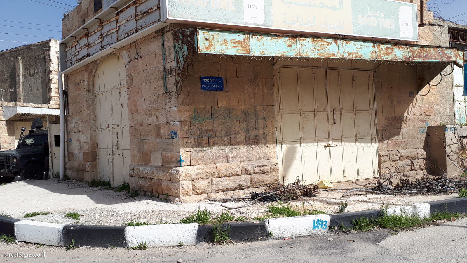 The deserted Al-Shuhada Street in Hebron, with a sign of King David Street