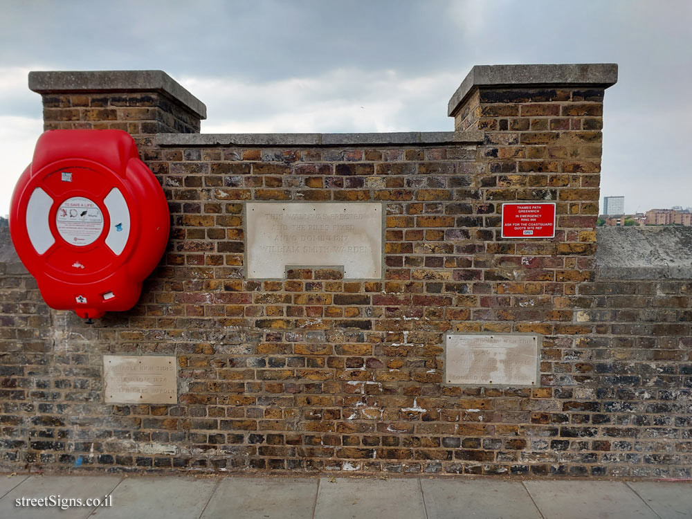 London - Greenwich - Signs on a wall on the bank of the Thames indicating the tide levels